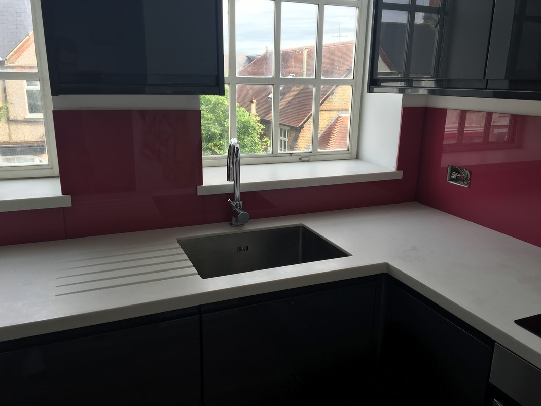 Deep plum coloured glass splashback in modern Bermondsey kitchen